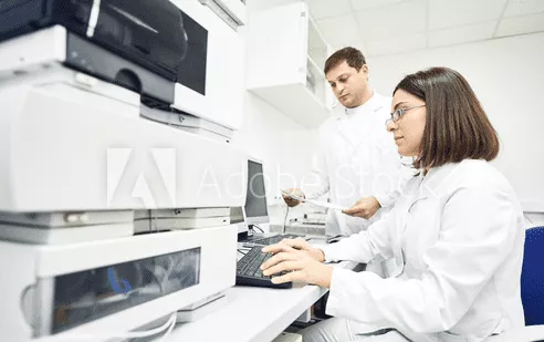 A women scientist performing High-Performance Thin Layer Chromatography in a laboratory
