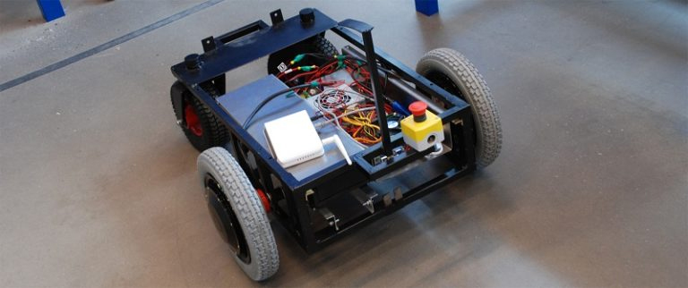 A compact robotic device with wheels, representing an automotive engineering homework help