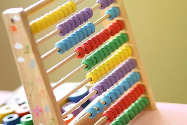 A wooden abacus with colourful beads, representing a calculus concept 