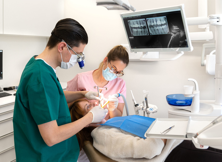 A dentist and two women in a dental office, highlighting oral health and professional dental care for Dentistry Homework Help