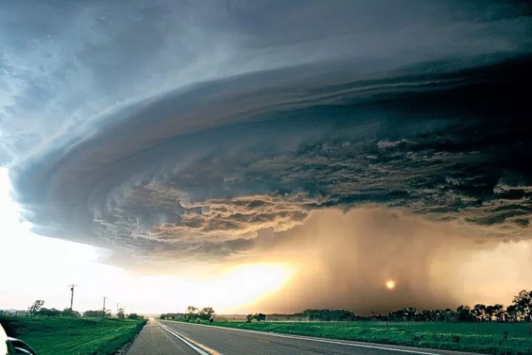 A large storm cloud looming over a road, illustrating the Dynamical Systems Assignment Help concept