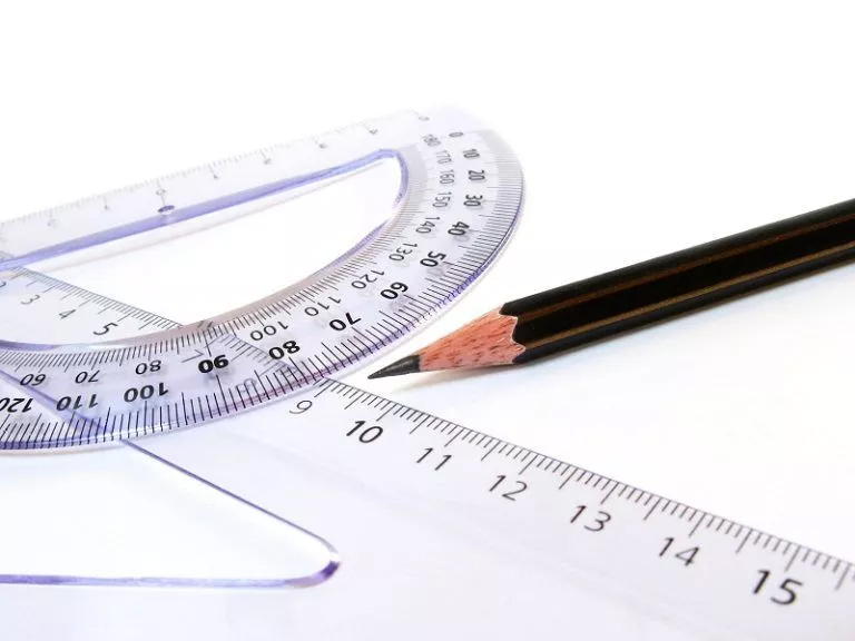 A ruler, pencil, and protractor on a white surface - essential tools for geometry homework help