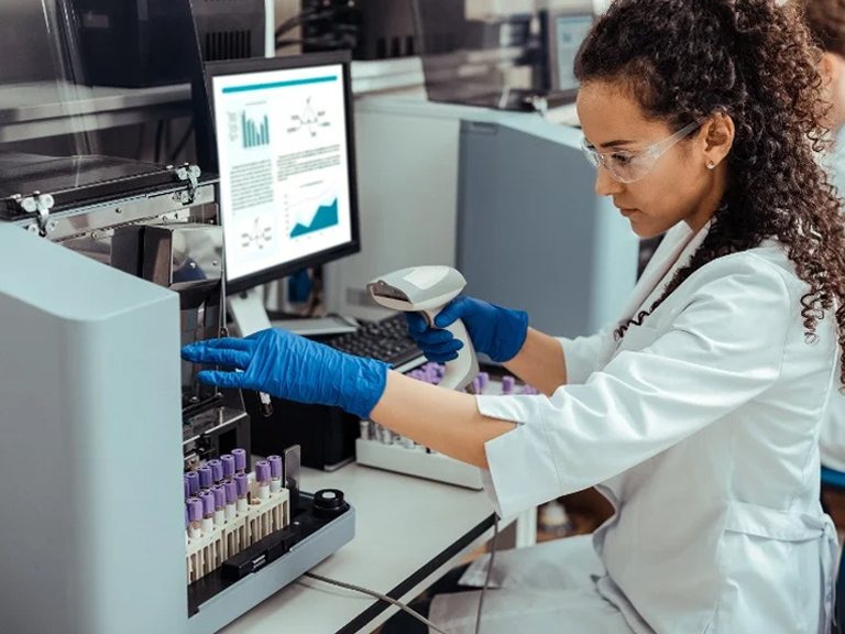 a female medical student with laptop or instrument seems to be indulge in laboratory science assignment task