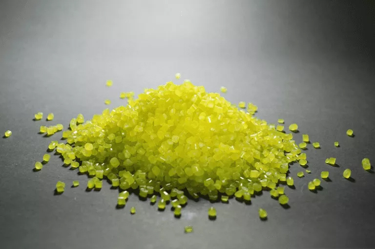 Yellow sugar pile on black surface, material science homework help