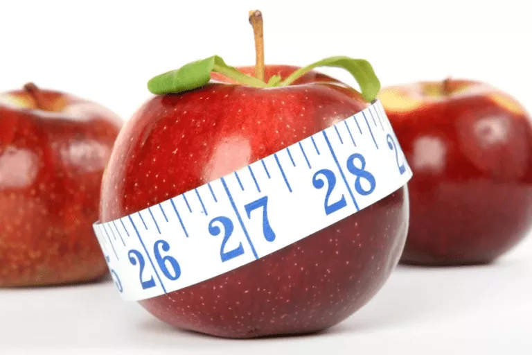 Fresh apples with a measuring tape wrapped around them, representing a Measure Theory Assignment Help concept