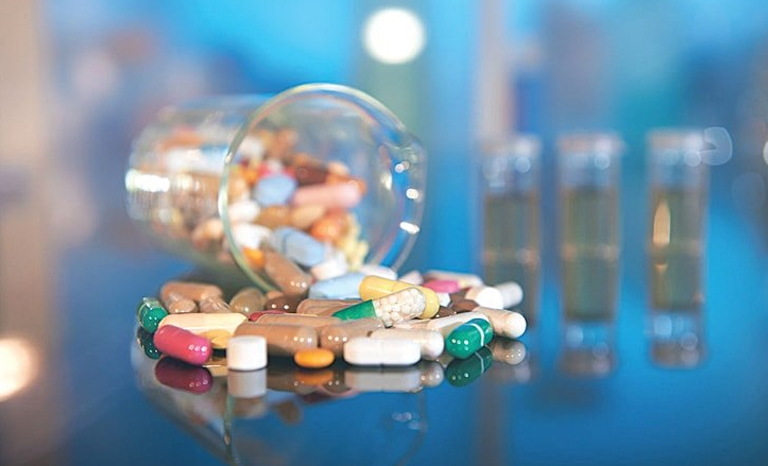 A glass jar filled with pills and other medications, representing pharmaceutics assignment help