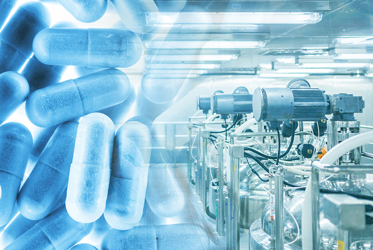 A variety of pills on a conveyor belt in a pharmaceutical factory