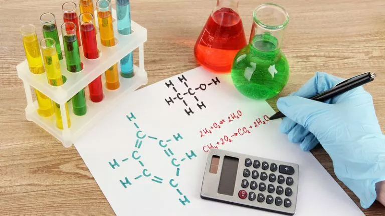 A chemistry student calculating a chemical formula using a calculator for their physical chemistry homework help