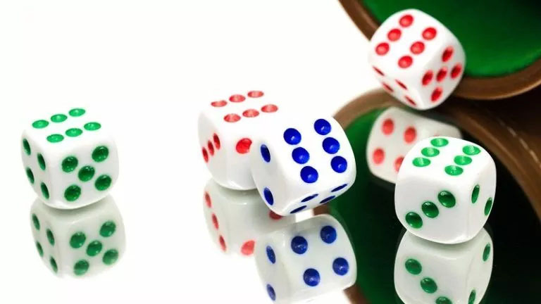 Green and white dice on a table, representing a Probability Homework Help concept