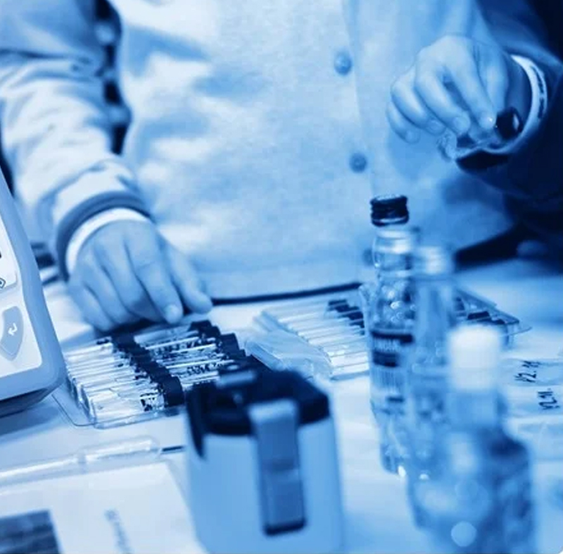 A student working on a computer with a bottle of water nearby focused on a spectroscopy assignment